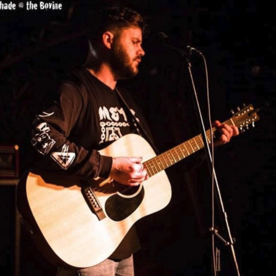 Terry Adshade playing acoustic guitar live